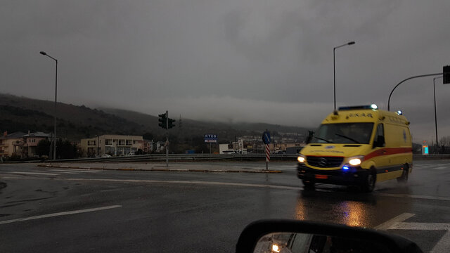 abulance moving fast in the nigth lights on  rainy weather asphalt