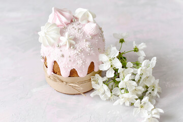 Easter still life. Baked Easter cake and cherry blossoms. soft pastel colors. Selective soft focus.