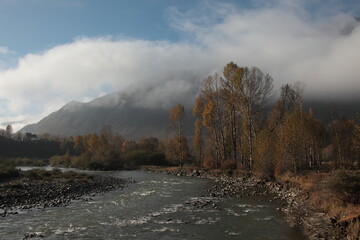 View of autumn scenery of Xinduqiao Town under sunrise and misty fog in Kangding County, Sichuan Province, China.