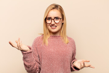 young blonde woman looking puzzled, confused and stressed, wondering between different options,...