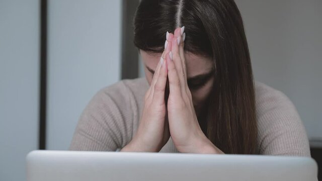 Woman headache is killing. Head shot close up stressed young woman looking screen of laptop think about correspondence. Frustrated female feeling a loser at home office. Problem at work