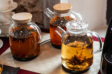 Transparent teapots with different teas are on the banquet table. Banquet or catering service