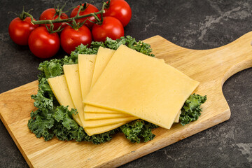 Sliced Gauda cheese over board