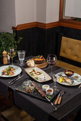 dining table food set with appetizer and drinks in restaurant