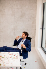 Young business man drinking champagne after Christmas party