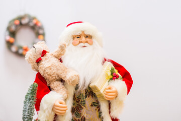 Santa claus decorating christmas tree on the white background