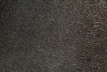 Dark gray asphalt texture. Background. Horizontal shot.