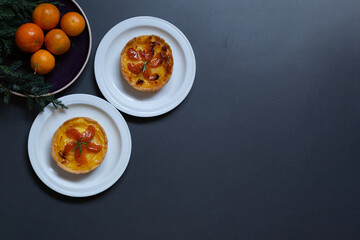 Mandarin orange cakes on grey background with copy space for your text