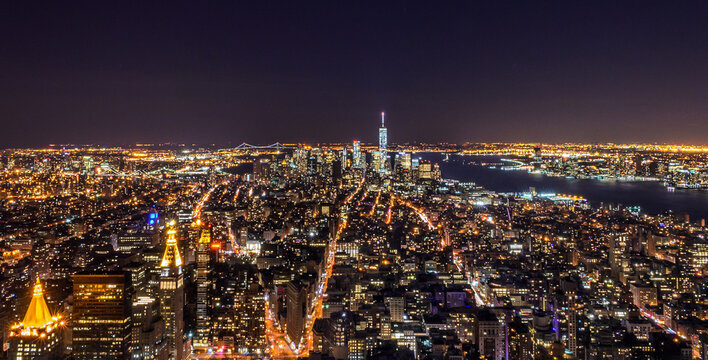 Breathtaking Panoramic and Aerial View of  Manhattan, New York City at Night. Beautiful,  Illuminated, Futuristic Buildings. Freedom Tower, Lady Liberty Statue, Hudson River.