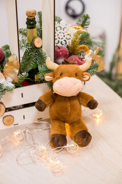 Toy bull ont the christmas tree, wooden bax with wooden decor. Zero waste christmas decor