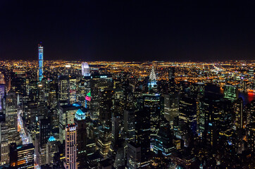Fototapeta premium Aerial View of Futuristic Buildings and Towers in Manhattan, New York City, USA. Illuminated Skyscrapers at the Big Apple. The City that Never Sleeps