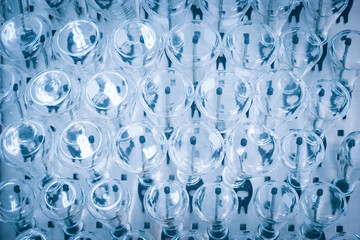 Glass flask in medical research lab or science laboratory. Blue tone. Selective focus.