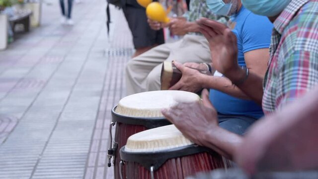 Salsa band plays in the street the count in the middle of the pandemic, to earn a living