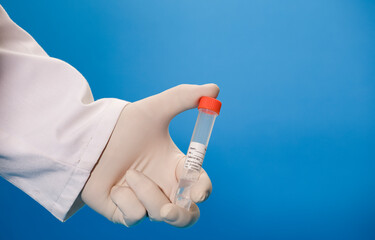 Serological test vial for laboratory in the hands of a doctor with surgical gloves and blue background