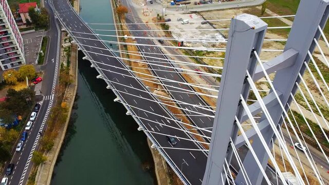 Ciurel passage, bridge over a river with moving cars, construction works near it. View from the drone. Bucharest, Romania