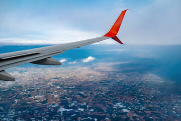 Airplane wing flying over Turkey, close-up. Air travel concept. View from the plane window to the map of the land. Natural abstract background