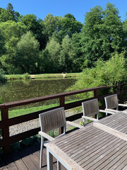 Fototapeta premium Wooden table and chairs on the lake shore