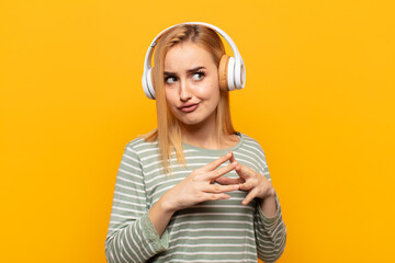 young blonde woman scheming and conspiring, thinking devious tricks and cheats, cunning and...
