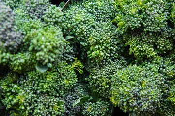 Close-up of the clustered flowers of broccoli heads at the Farmer' Market, beautiful fresh vegetable from brasica family with versatile uses in vegetarian or vegan dishes, as a side dish or as a snack
