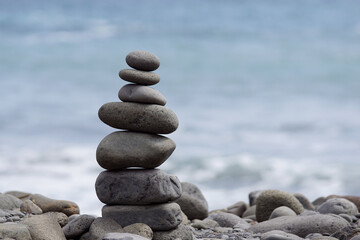 Fototapeta na wymiar stone stack, tower or pyramid of stones on the beach, balance