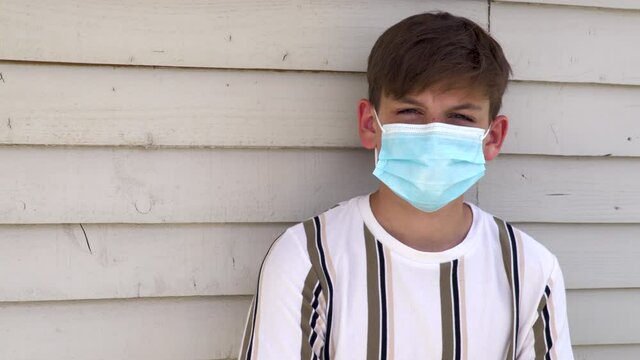 Teenage boy wearing face mask outside during Coronavirus COVID-19 Pandemic