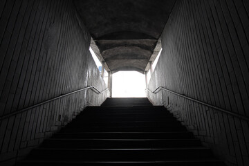Fototapeta na wymiar Stairs to the dark underpass, entrance to the dark underpass, view from inside.