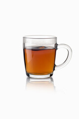 Tea in a transparent glass mug on a white background