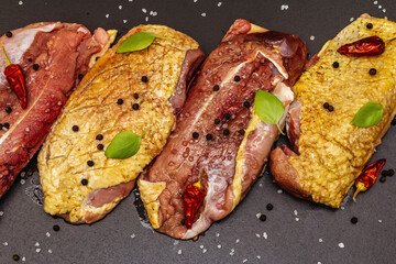 Raw duck breasts with sea salt, fresh basil, chili and spices