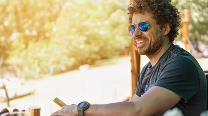 Afro-American ethnic man with his phone in hand waiting for lunch