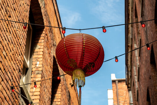 red lantern hanging in an alley in the Chinatown of Victoria, BC Canada