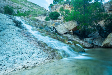 A small beautiful waterfall with the rocks.