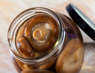 Close-up of tasty natural marinated mushrooms shiitake in glass jar
