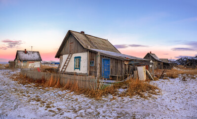 Panoramic view of old house against the Arctic sky. Old authentic village of Teriberka. Kola Peninsula.