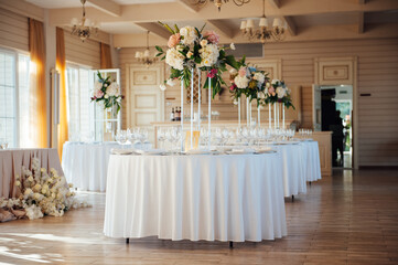 A beautiful vase of flowers on a table in a luxury restaurant. Wedding decorations