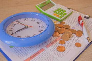 finance business calculation. coin stack with a clock background