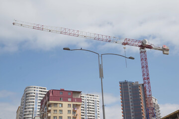 Silhouettes of cargo cranes in city. Building cranes building new building construction