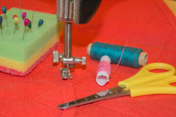 Sewing still life: colorful cloth. Sewing kit includes threads of different colors, thimble and other sewing accessories