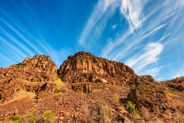 Looking up at ridge under blue skies