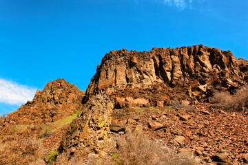 Looking up at ridge under blue skies