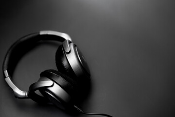 Headphones lie on a black background