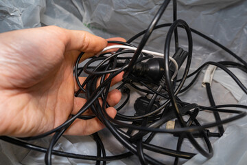 chaotic pile of wires and cables in your hand. The problem of storing cables and charging cords.