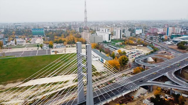 Ciurel passage, bridge over a river with moving cars, construction works near it. View from the drone. Bucharest, Romania