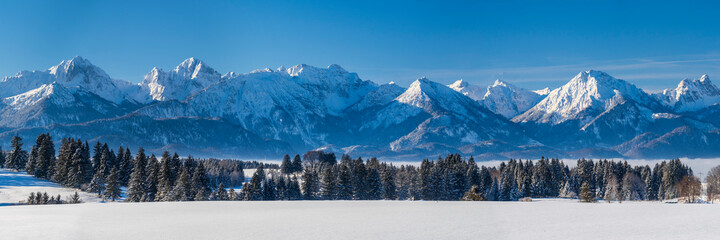 panoramic winter landscape in Germany, Bavaria, and alps mountain range