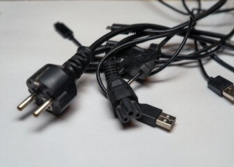 Lots of USB, HDMI cables and charging plugs. lots of tangled cables. tangle of tangled cables from home electronics