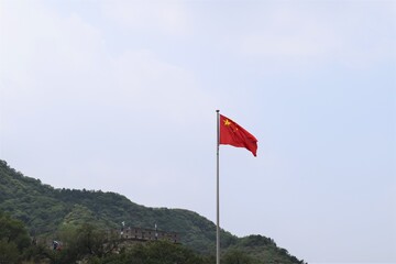 A Waving China Flag Standing at the Great Wall Beijing China