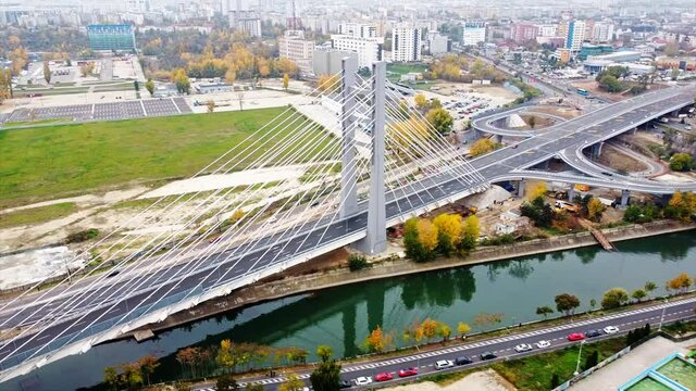 Ciurel passage, bridge over a river with moving cars, construction works near it. View from the drone. Bucharest, Romania