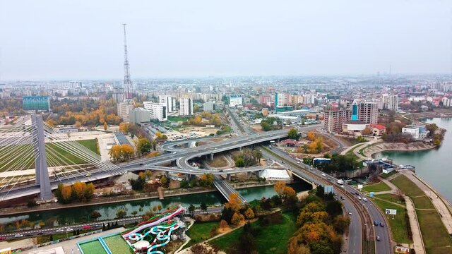 Ciurel passage, bridge over a river with moving cars, construction works near it. View from the drone. Bucharest, Romania