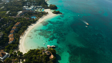 Travel concept: sandy beach and hotels near the blue lagoon, from above, Boracay, Philippines. Seascape with beach on tropical island. Summer and travel vacation concept.