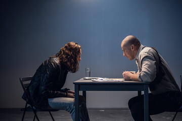 A police detective suspects a white man of committing a crime. Conducts an interrogation with the presentation of evidence in the interrogation room