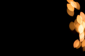 Christmas background overlay. Abstract Christmas dark background with defocused garland. Dark background for christmas design. Golden bokeh lights on black background.